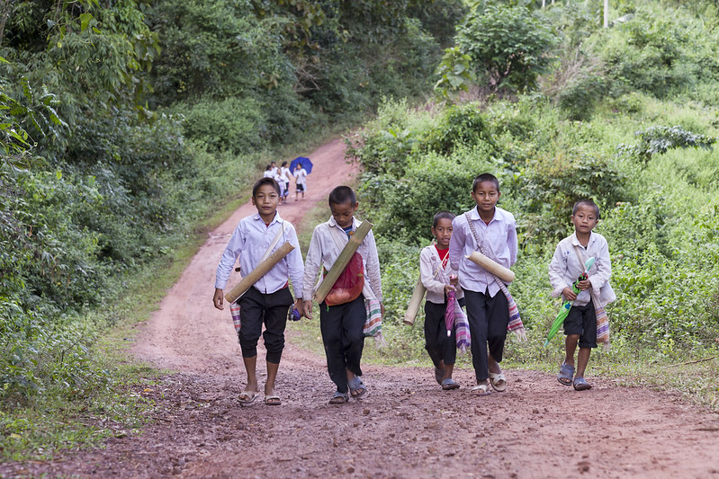 These children walk home from school after a more enjoyable learning experience and with a full stomach. More parents are now sending their children to school. Oudomxay province, Lao PDR.