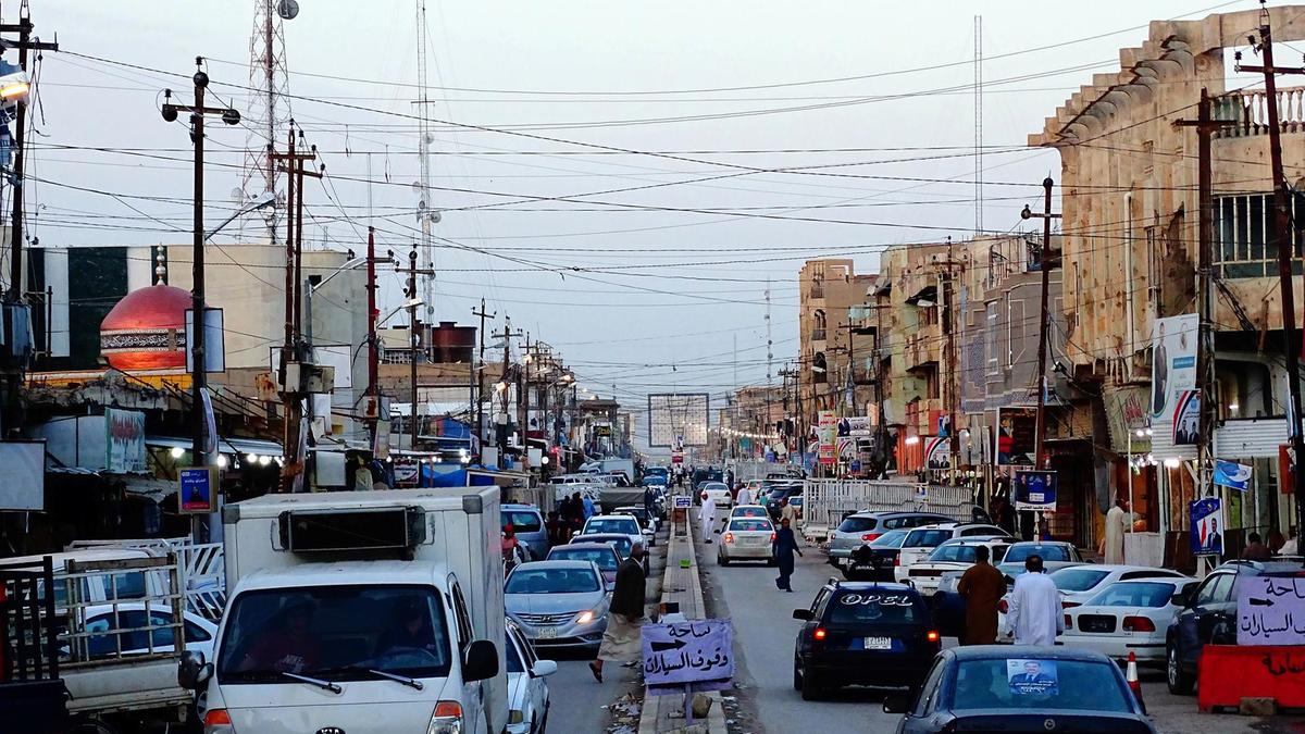 Traffic at dusk on one of Fallujah's main roads, 70km west of Baghdad. Photo source: Imad Mohammed for The National